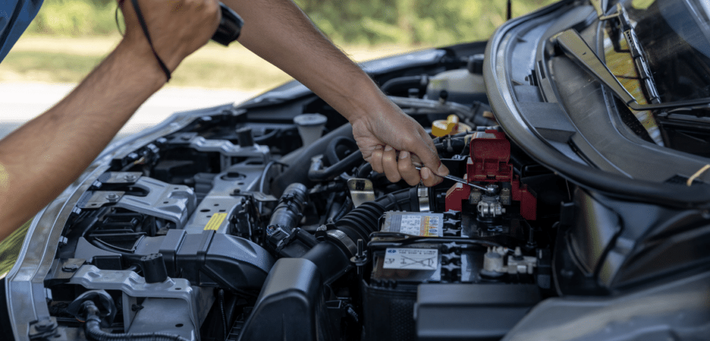 Skilled mechanic performing a mobile battery replacement in Orlando, ensuring quick and reliable battery service at your location.
